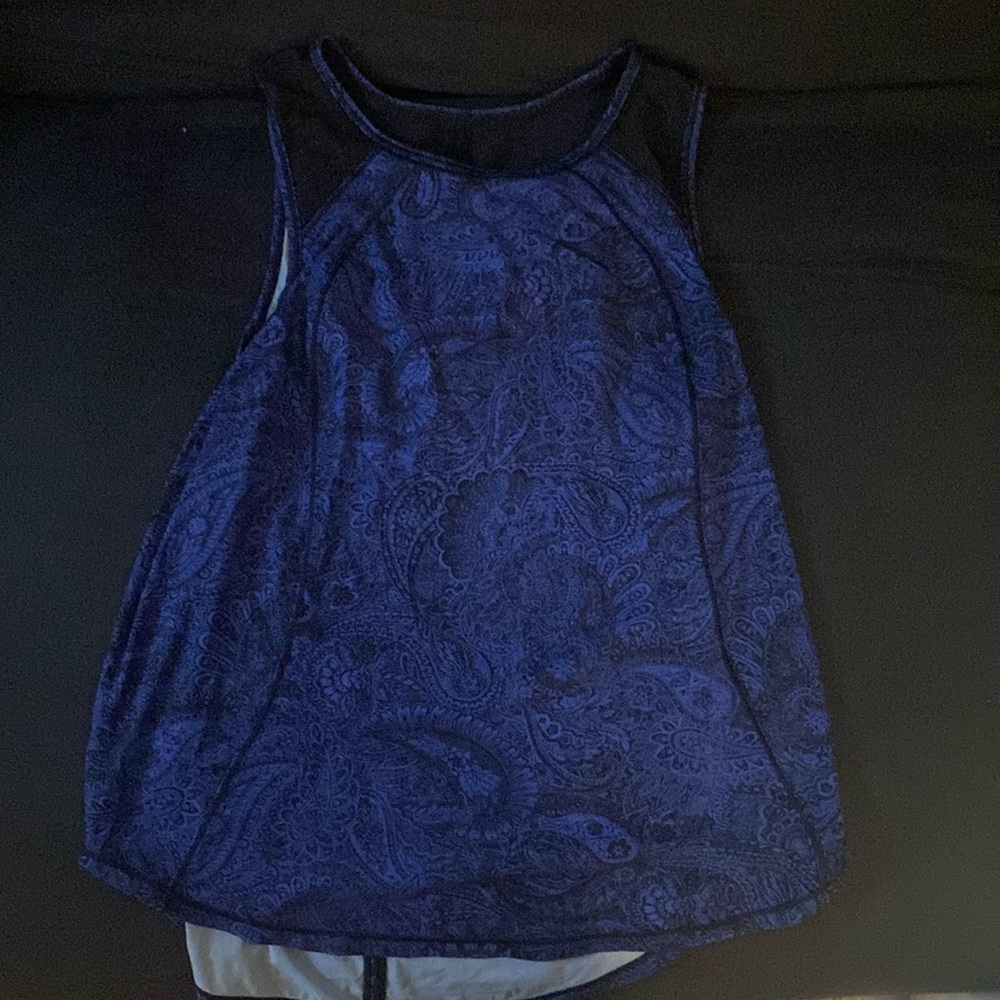Deep blue lululemon tank top with black sheer details, open back & floral print.